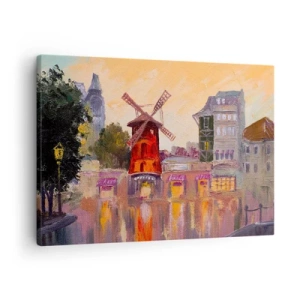 Vászonkép - A Moulin Rouge piros szélmalma a városkép ölelésében - 70x50cm - Párizsi ikonok - Moulin Rouge - Modern fali dekoráció nappalihoz és hálószobához ARTTOR