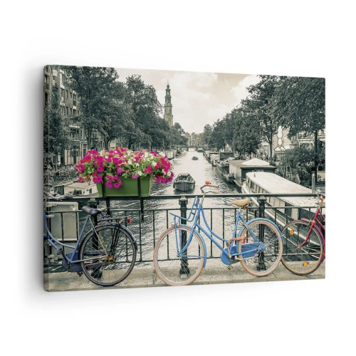 Vászonkép - Egy híd kerékpárokkal és virágokkal egy csatorna felett Amszterdamban - 70x50cm - Az amszterdami utca színei - Modern fali dekoráció nappalihoz és hálószobához ARTTOR
