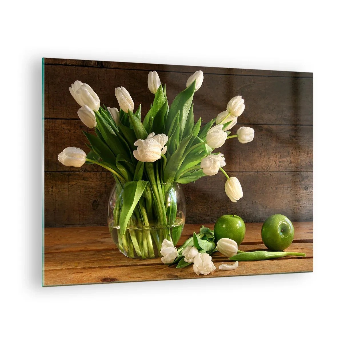 Üveg kép - Egy váza fehér tulipánokkal és zöld almával egy fából készült asztalon - 70x50cm - Zamatos és friss zöldben és fehérben - Modern fali dekoráció nappalihoz és hálószobához ARTTOR