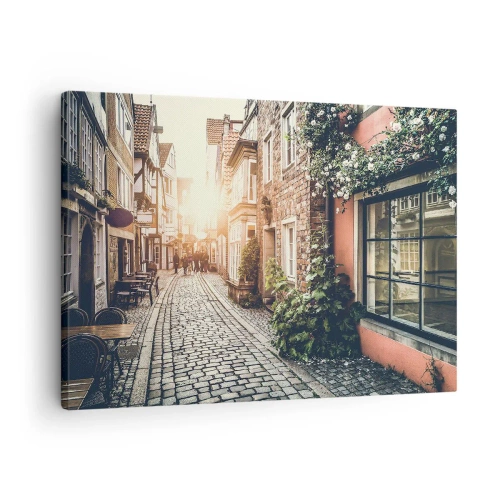 Vászonkép - Egy bájos utca kőburkolattal és virágokkal - 70x50cm - Rózsa sikátor rózsaszín fényben - Modern fali dekoráció nappalihoz és hálószobához ARTTOR