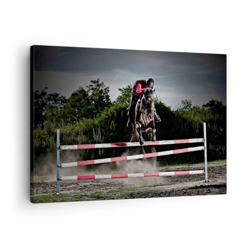 Vászonkép - Egy lovas ugrik át egy akadályon a versenypályán - 70x50cm - Együtt a győzelemért - Modern fali dekoráció nappalihoz és hálószobához ARTTOR
