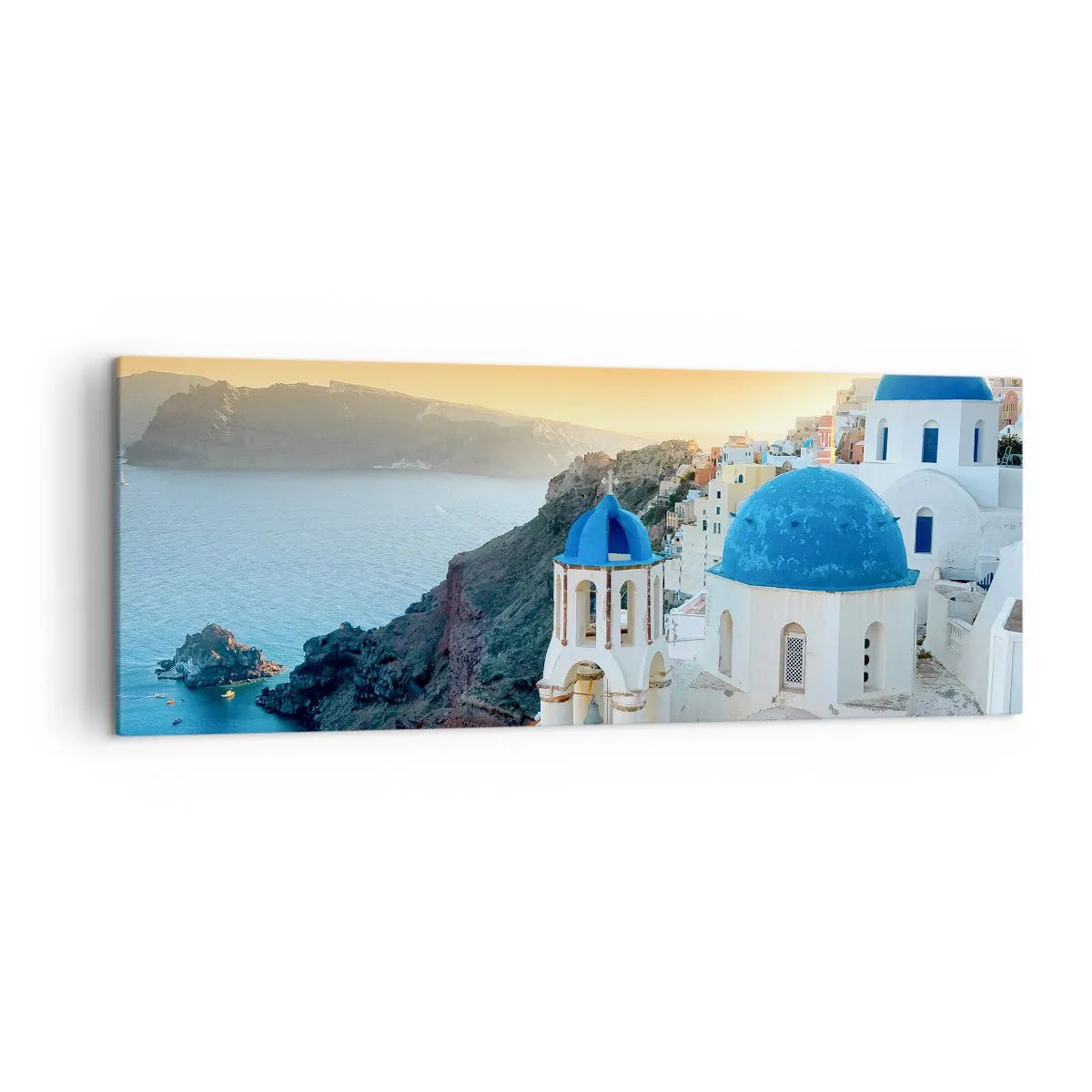 Vászonkép - Santorini – rásimulva a sziklákra - 140x50 cm