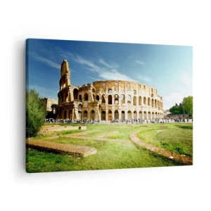 Vászonkép - A római Colosseum zöld növényzettel és kék éggel körülvéve - 70x50cm - Még mindig halljuk a pisztoly csörömpölését - Modern fali dekoráció nappalihoz és hálószobához ARTTOR
