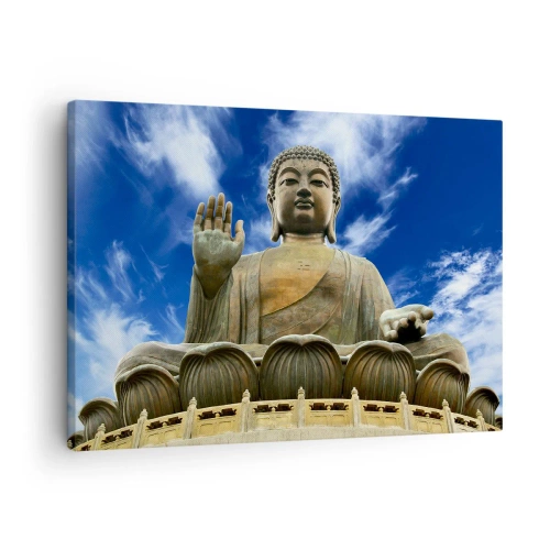 Vászonkép - Egy monumentális Buddha-szobor a kék ég és a felhők ellen - 70x50cm - Élj félelem nélkül - Modern fali dekoráció nappalihoz és hálószobához ARTTOR