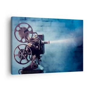 Vászonkép - Egy régi filmvetítő kék háttér előtt világít - 70x50cm - A régi moziban - Modern fali dekoráció nappalihoz és hálószobához ARTTOR