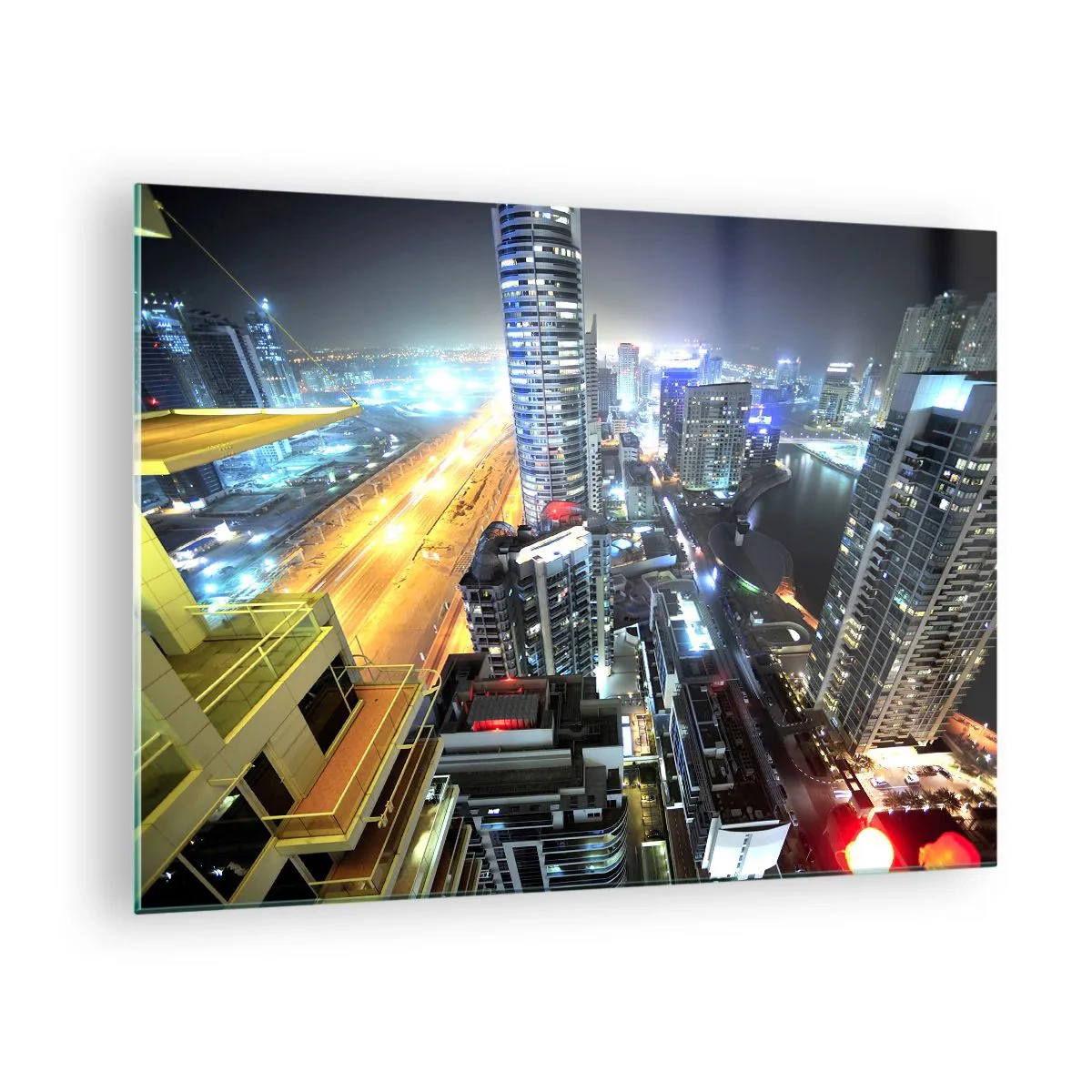Üveg kép - Az éjszakai város panorámája kivilágított felhőkarcolókkal - 70x50cm - Csoda a sivatagban - Modern fali dekoráció nappalihoz és hálószobához ARTTOR