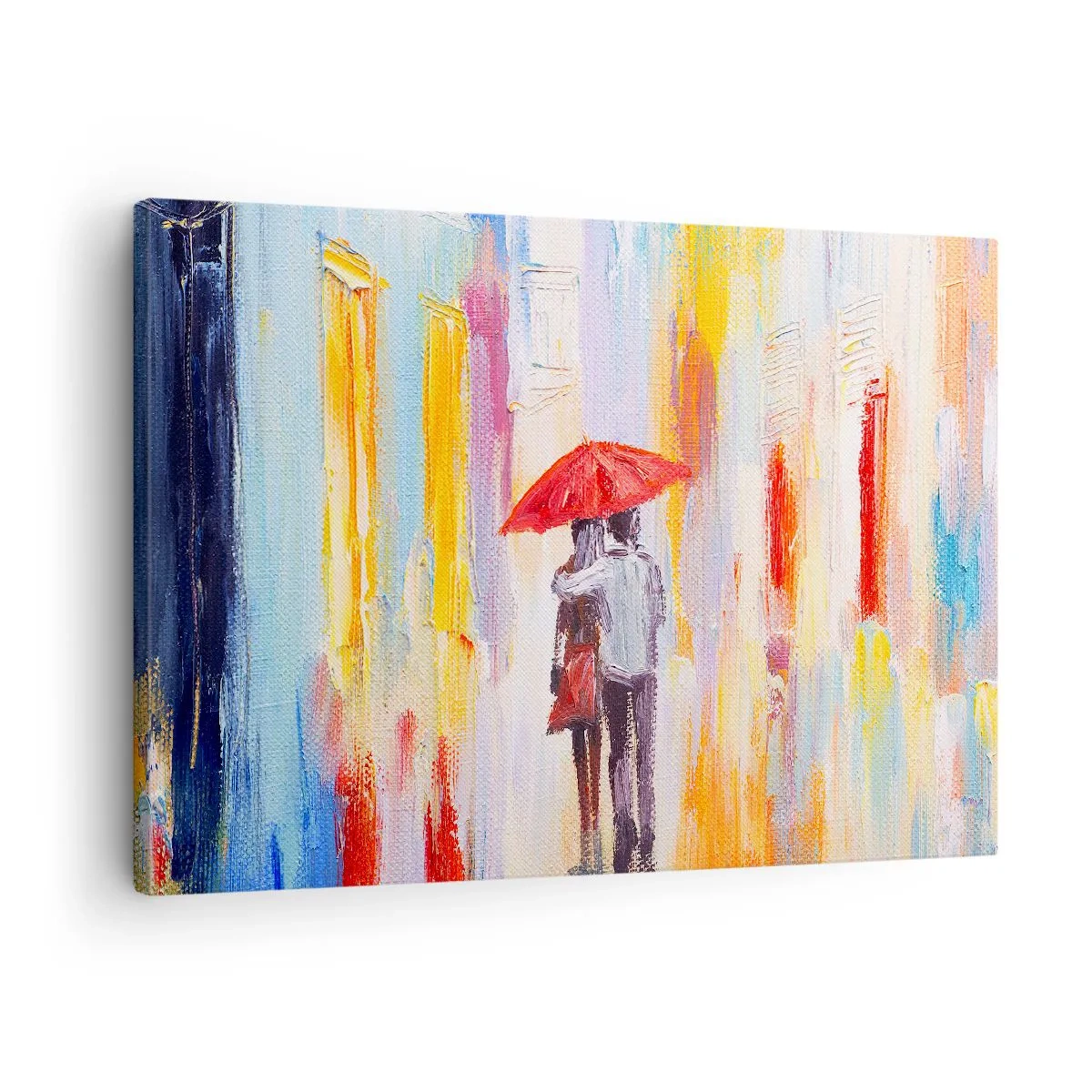 Vászonkép - Egy pár egy piros esernyő alatt, színes épületekkel a háttérben. - 70x50cm - Hadd essen az eső - Modern fali dekoráció nappalihoz és hálószobához ARTTOR
