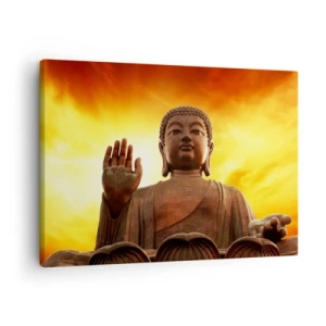 Vászonkép - Egy Buddha-szobor az aranyló naplemente előtt - 70x50cm - A világ békéje - Modern fali dekoráció nappalihoz és hálószobához ARTTOR