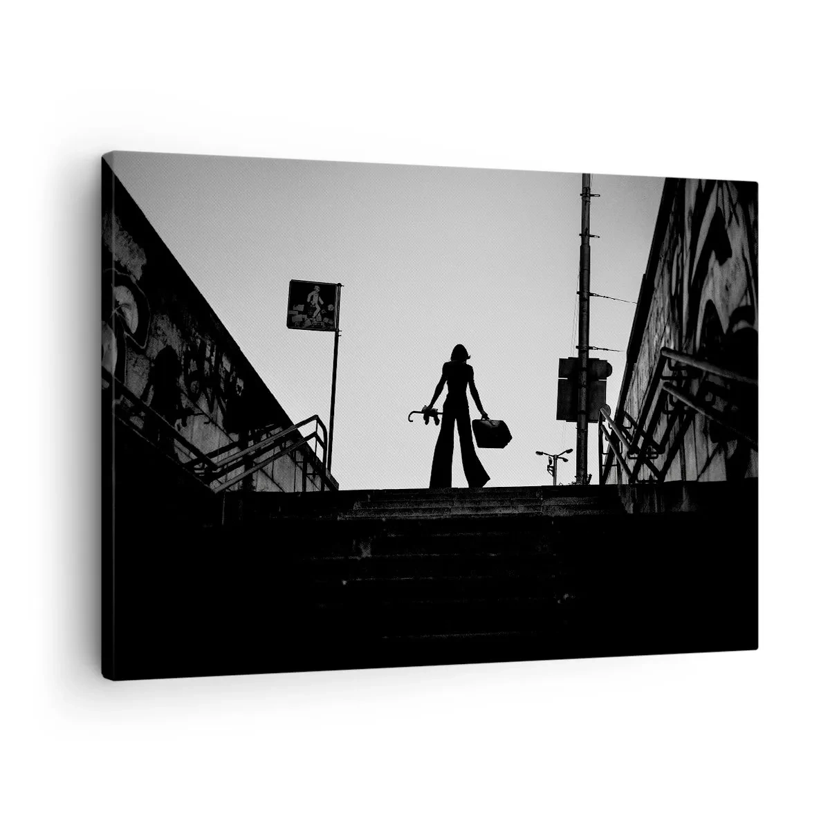 Vászonkép - Egy női alak a lépcsőn fekete-fehérben, dinamikus hangulattal - 70x50cm - Városi vándorlás - Modern fali dekoráció nappalihoz és hálószobához ARTTOR