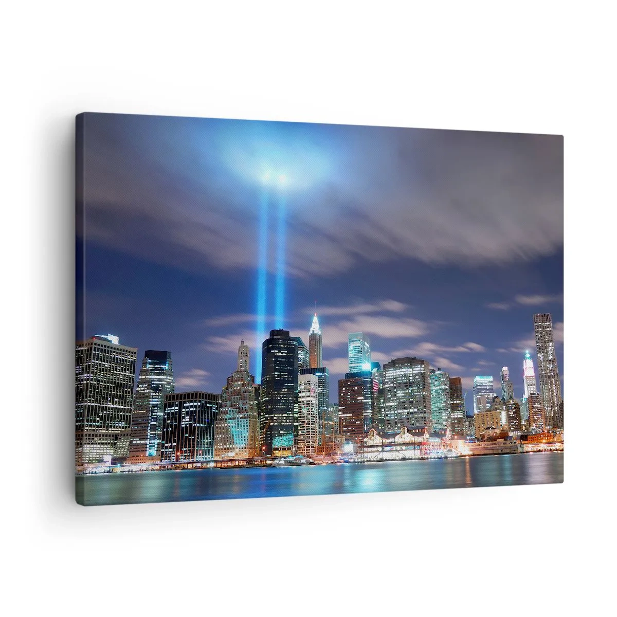 Vászonkép - Éjszakai város panorámája két fényes fénysugárral az égen - 70x50cm - Érd el a fénnyel az eget - Modern fali dekoráció nappalihoz és hálószobához ARTTOR