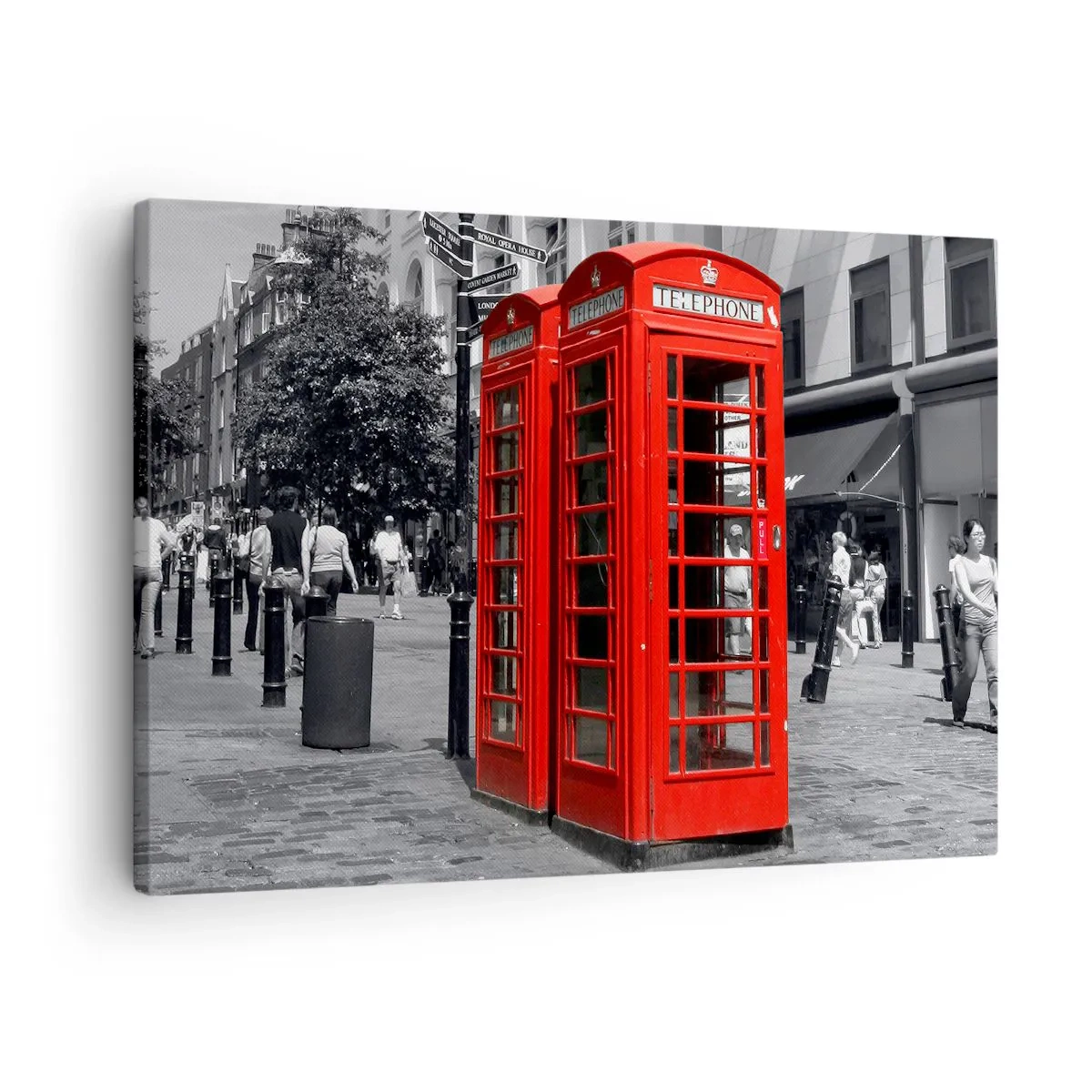 Vászonkép - Piros telefonfülkék fekete-fehér városi háttér előtt. - 70x50cm - Piros telefonfülkék - Modern fali dekoráció nappalihoz és hálószobához ARTTOR