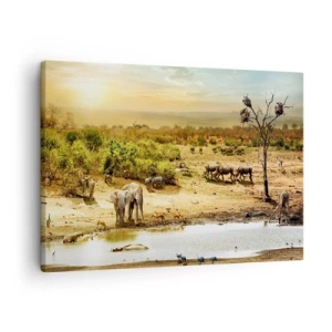 Vászonkép - Elefántok és vadon élő állatok egy itatóhelyen naplementekor - 70x50cm - „Z Edenu zaś wypływała rzeka…" - Modern fali dekoráció nappalihoz és hálószobához ARTTOR